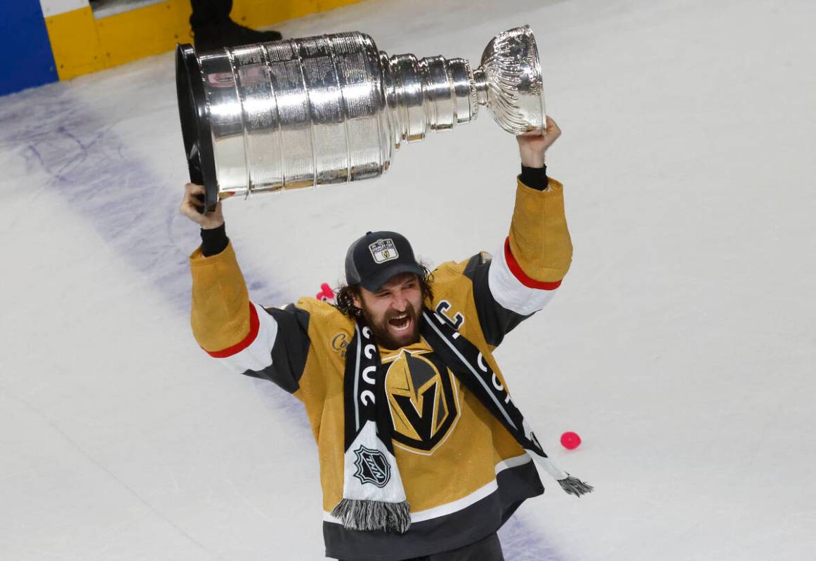 Golden Knights right wing Mark Stone (61) hoists the Stanley Cup after Golden Knights beat Flor ...