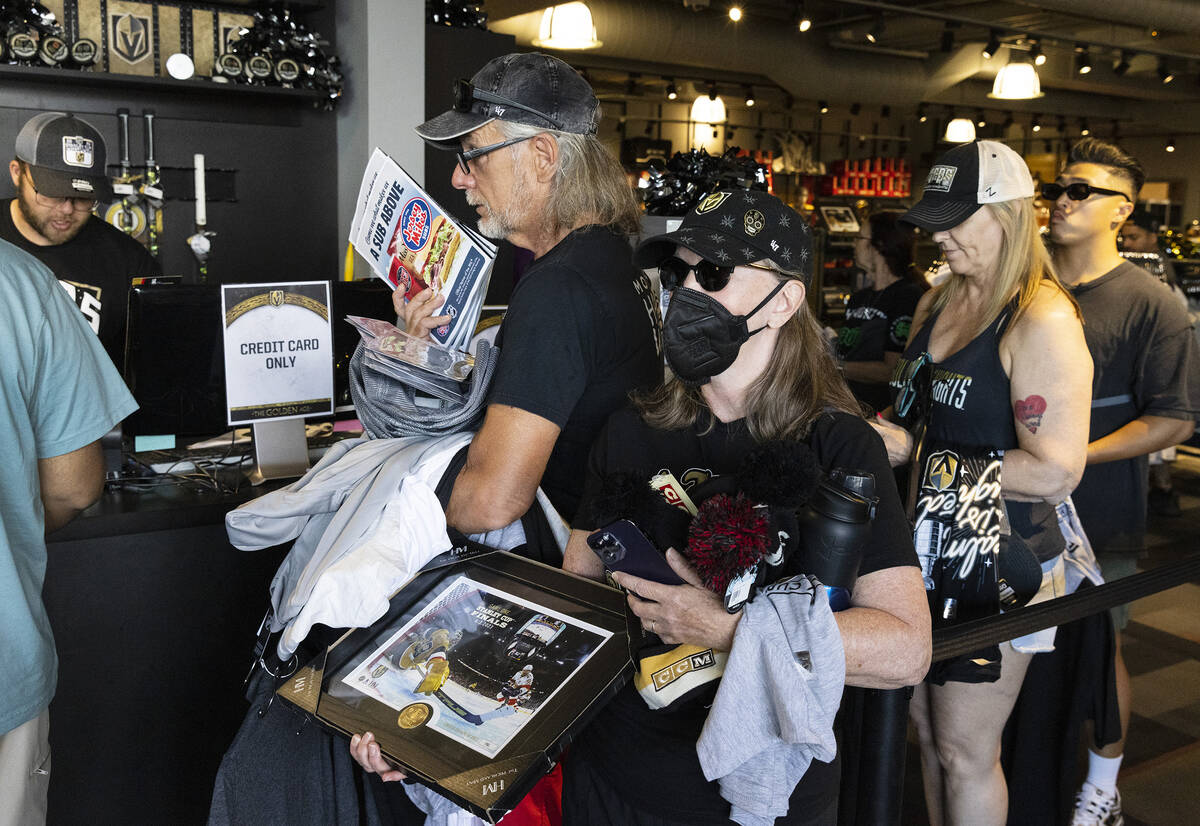 Golden Knights fans, including Joe Hochhalter, left, and his wife Vicki cary their Stanley Cup ...