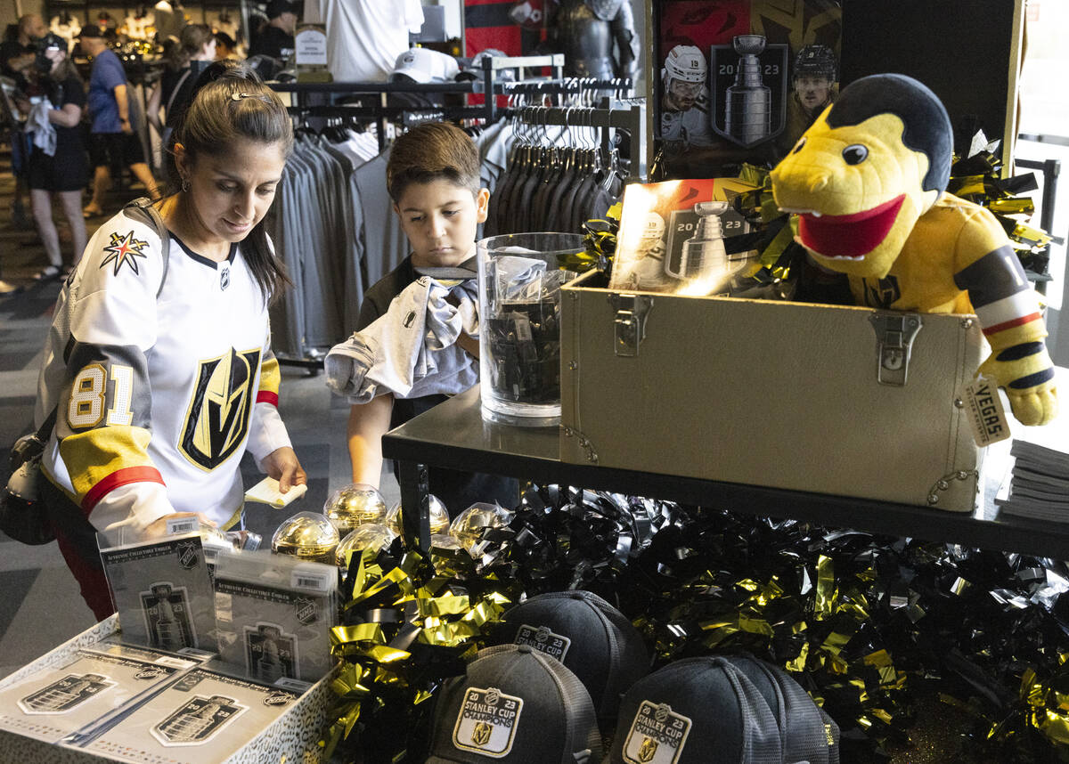 Christina F. and her son Daniel, 9, shop Golden Knight's Stanley Cup championship merchandise a ...