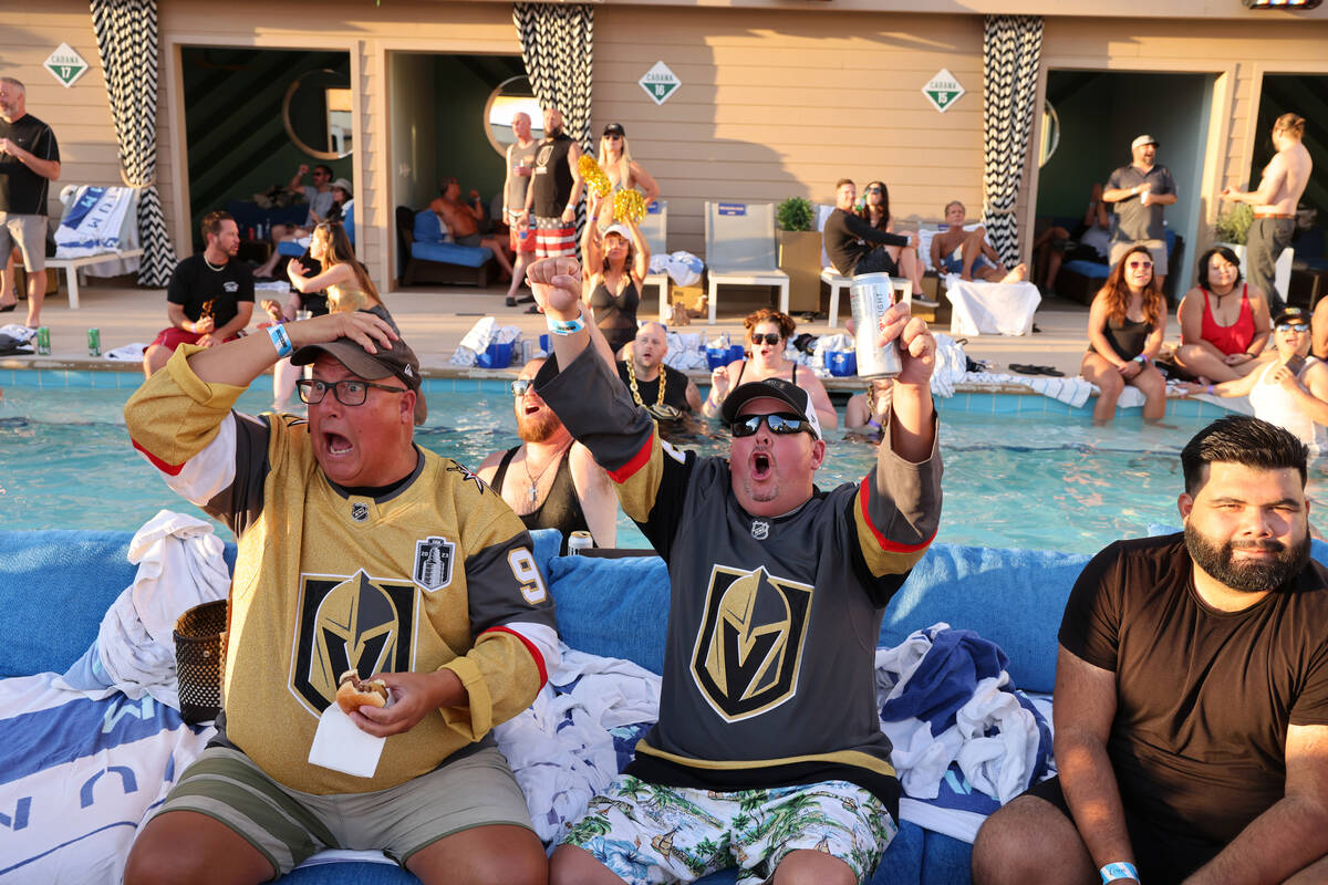 Golden Knights fans Mike Pare, left, and Jeremy Clement react to a save during Game 5 of the St ...