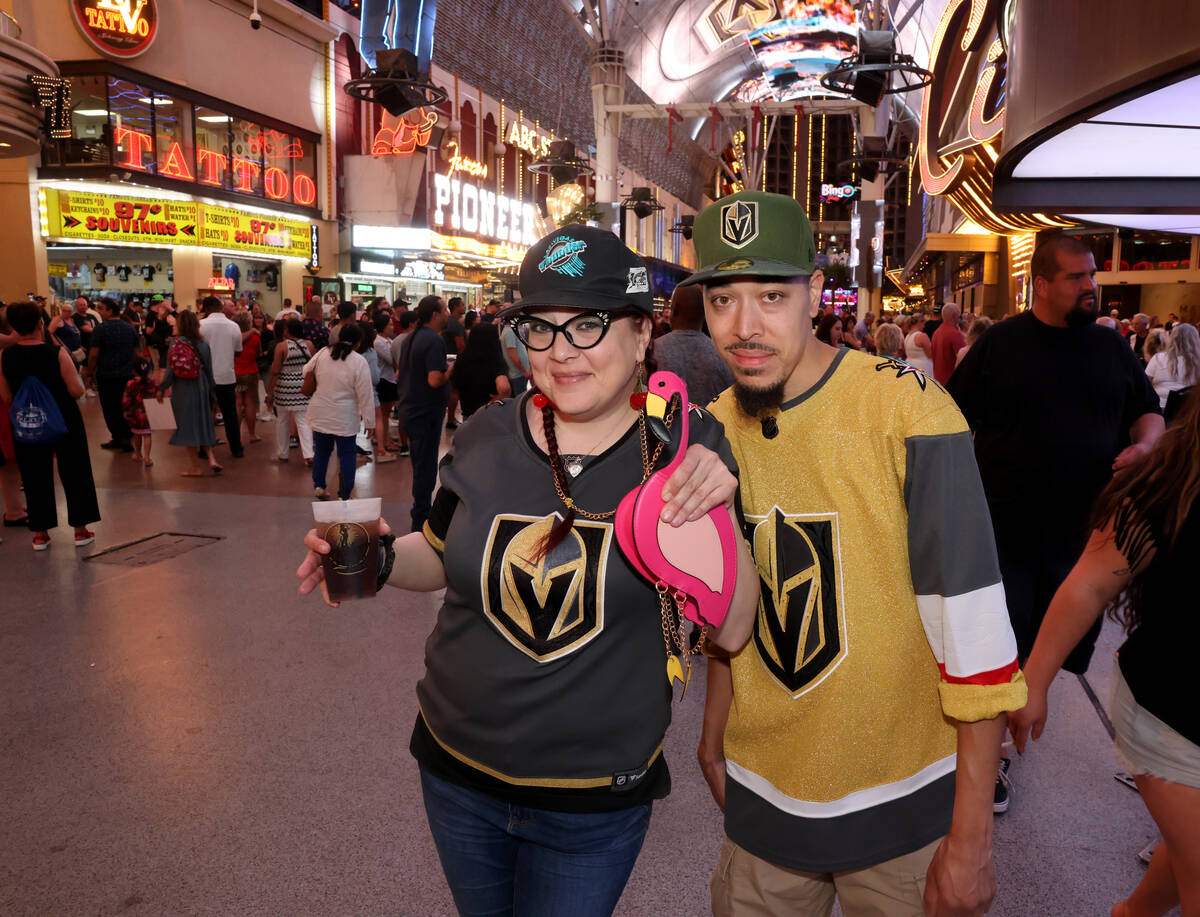 Golden Knights fans Deanna Rilling, left, and Michael Chapman celebrate at the Fremont Street E ...