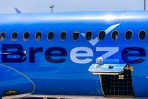 A Breeze Airways passenger looks out the window as their inaugural flight arrival makes it to t ...