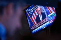 A news conference by Federal Reserve Chairman Jerome Powell is displayed on the floor at the Ne ...