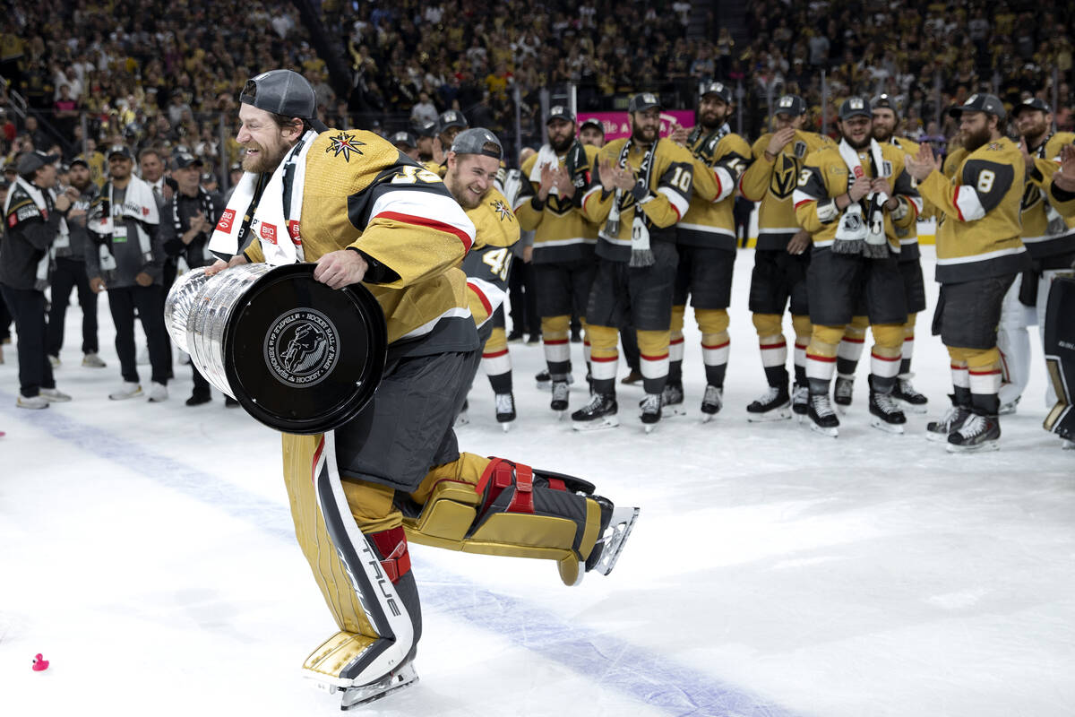 Golden Knights goaltender Adin Hill (33) skates with the Stanley Cup after his team defeated th ...