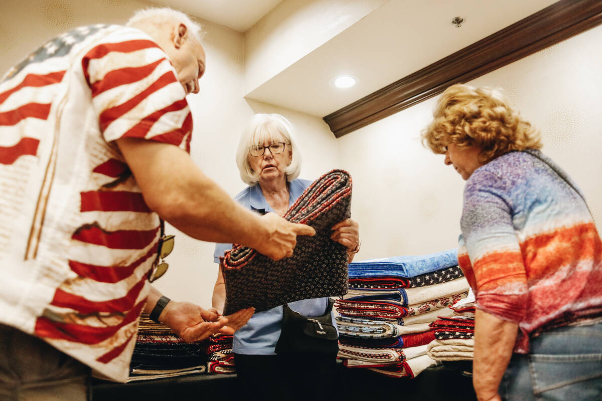Wanda Smith, one of the volunteer quilt-makers, gets quilts in order to be handed out to Vietna ...