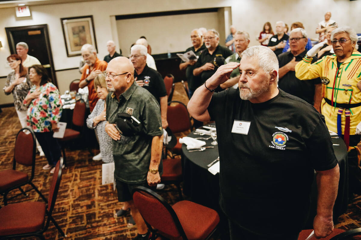 Mike Masello stands for the Pledge of Allegiance along with other Vietnam War veterans during a ...