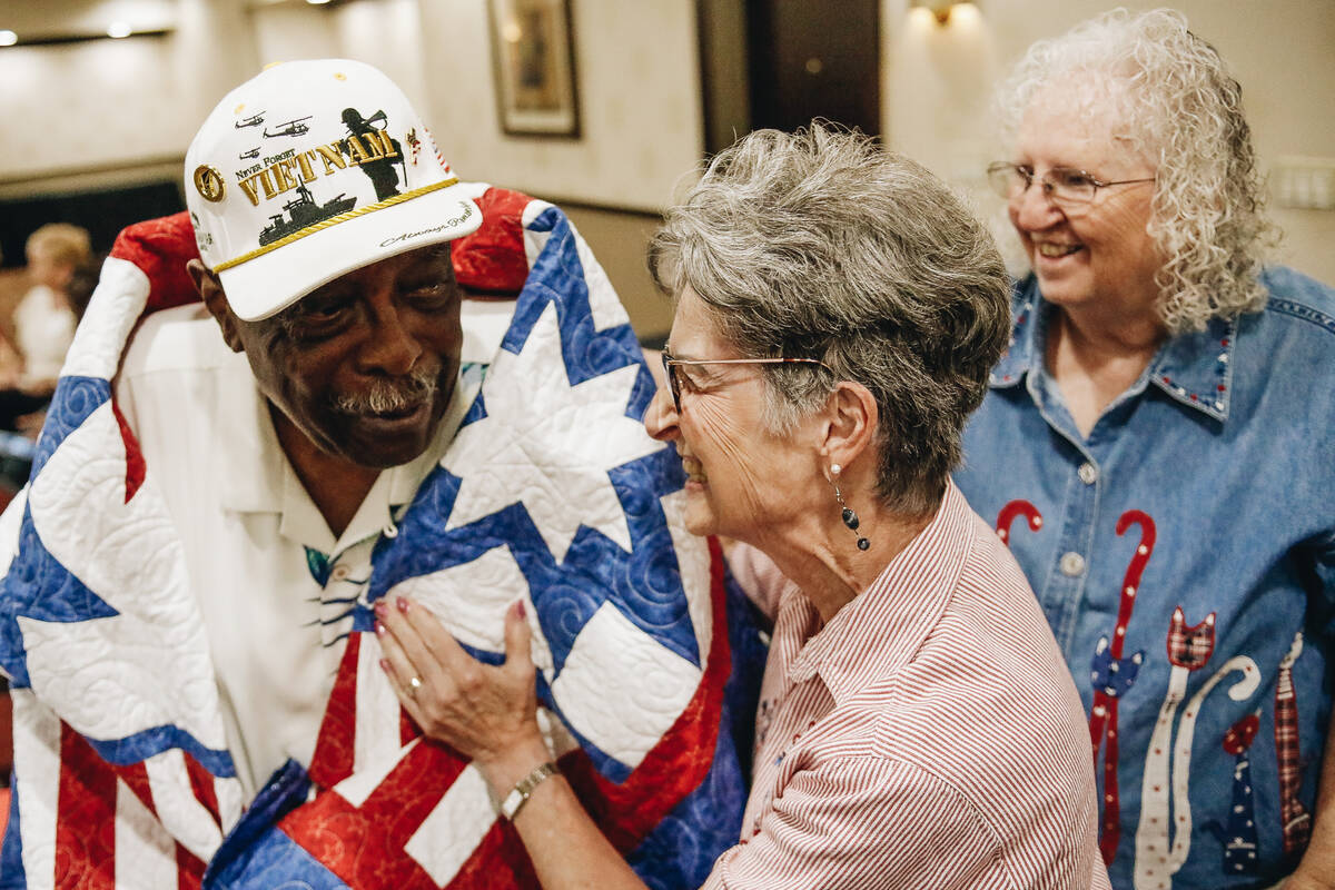 Willie McTear, left, thanks Carole Nelson, a volunteer with the Quilts of Valor Foundation, for ...