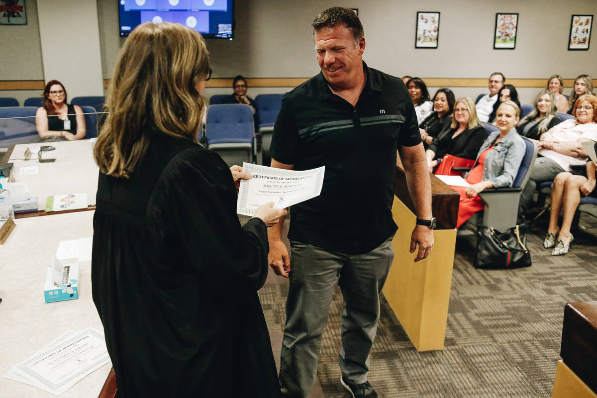 Brett Schaefer is awarded a certificate upon completing Court Appointed Special Advocate volunt ...