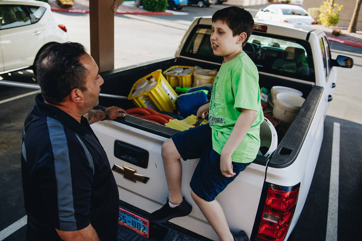 Alex Garcia, 12, left, talks to his dad, Brian Garcia, before going to the grocery store on Thu ...