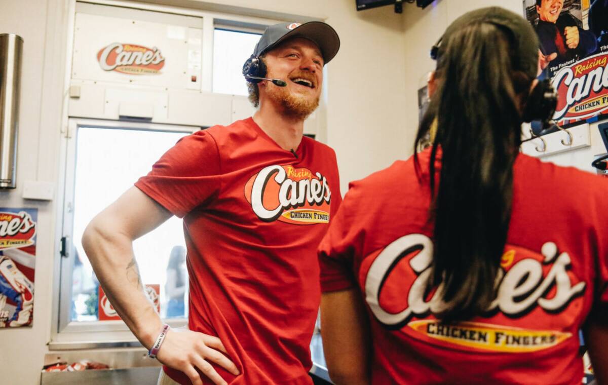 Golden Knights center Jack Eichel takes orders from fans in the Raising Canes drive-thru on Fri ...