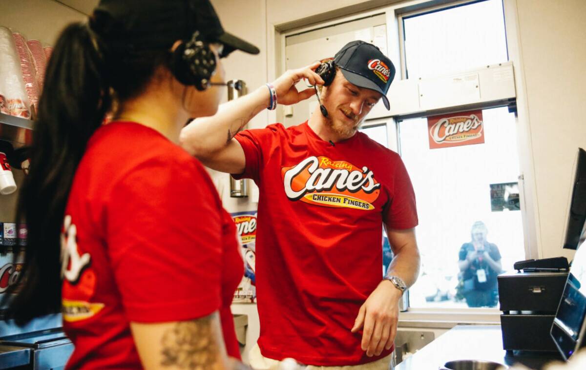 Golden Knights center Jack Eichel takes orders from fans in the Raising Canes drive-thru on Fri ...