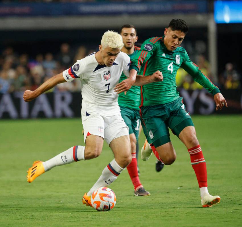 USA’s Giovanni Reyna (7) controls the ball against Mexico's Edson Álvarez (4) durin ...