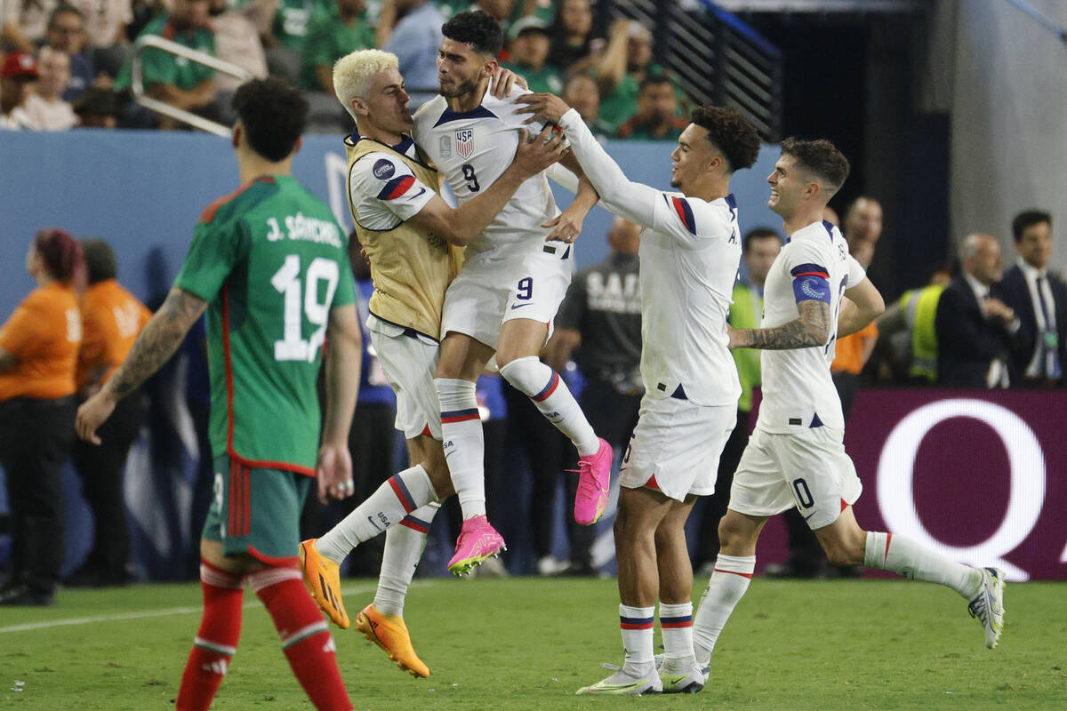 USA’s Ricardo Pepi (9) celebrates with his teammates after he scored a goal against Mexi ...