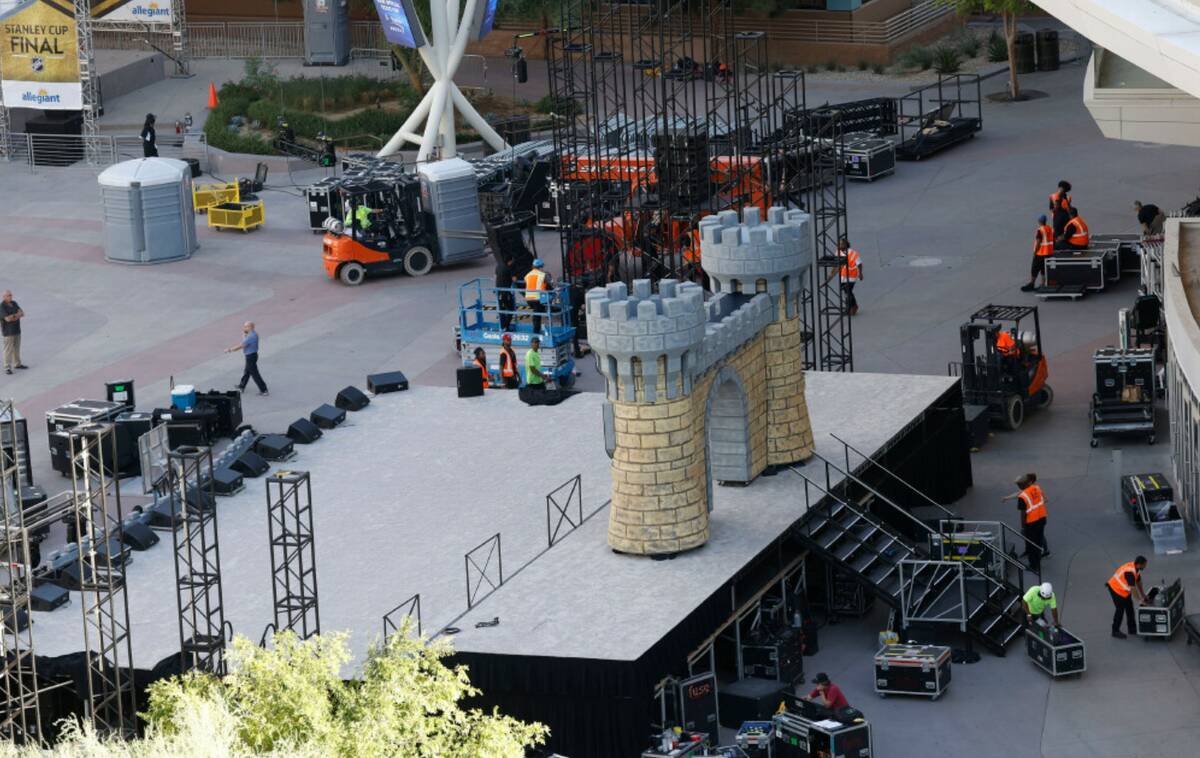 Workers set up the stage for the Stanley Cup victory parade and rally outside T-Mobile Arena on ...