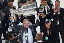 Golden Knights General Manager Kelly McCrimmon hoists the Stanley Cup as Golden Knights Chairma ...
