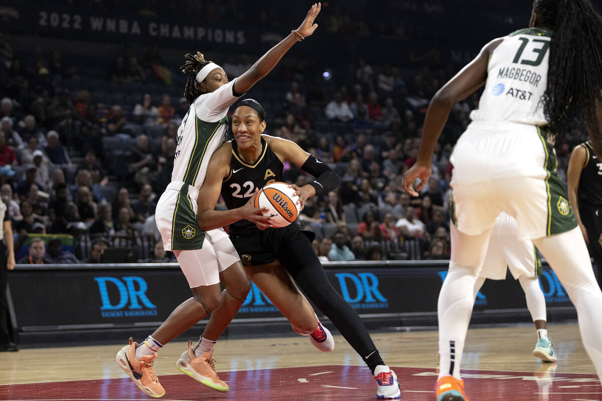 Las Vegas Aces forward A'ja Wilson (22) drives past Seattle Storm guard Yvonne Turner, left, du ...