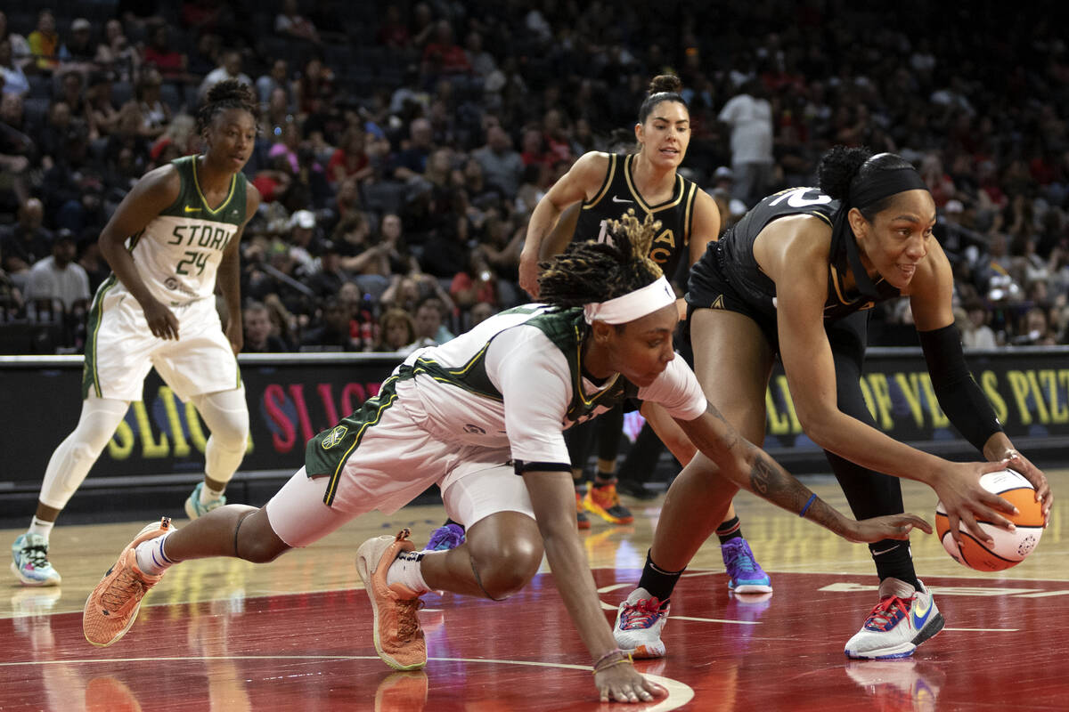 Las Vegas Aces forward A'ja Wilson (22) steals possession from Seattle Storm guard Yvonne Turne ...