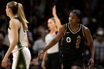 Las Vegas Aces guard Jackie Young (0) signals after scoring a 3-pointer on the Seattle Storm du ...