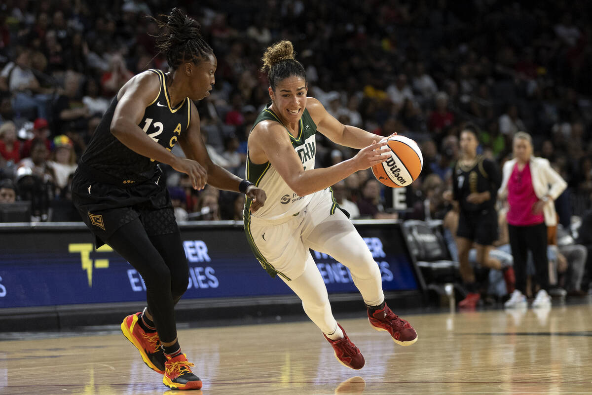 Seattle Storm guard Kia Nurse, right, drives around Las Vegas Aces guard Chelsea Gray (12) duri ...