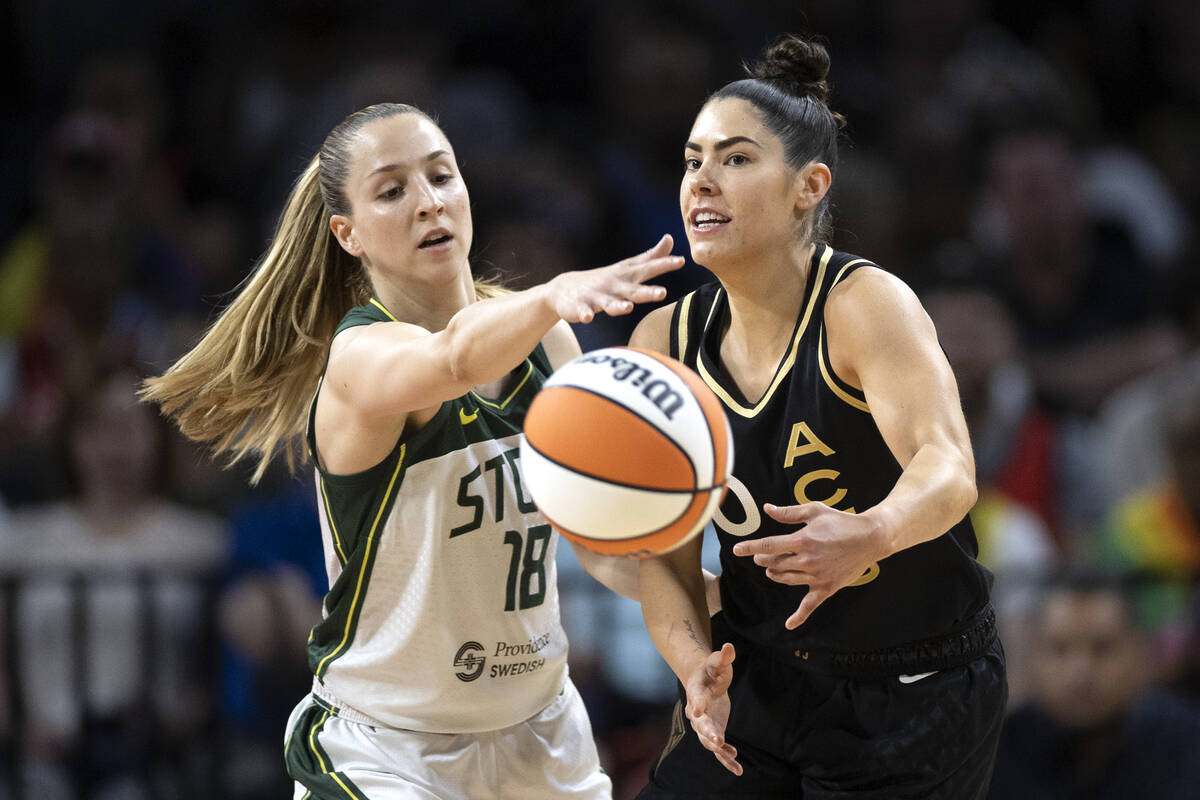 Seattle Storm guard Ivana Dojkic (18) reaches for the ball while Las Vegas Aces guard Kelsey Pl ...