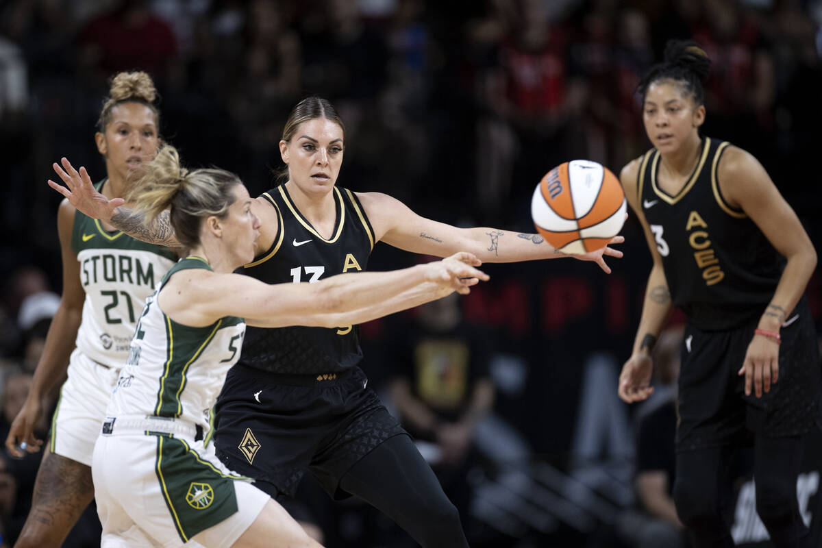 Seattle Storm guard Sami Whitcomb (32) passes while Las Vegas Aces forward Cayla George (13) gu ...