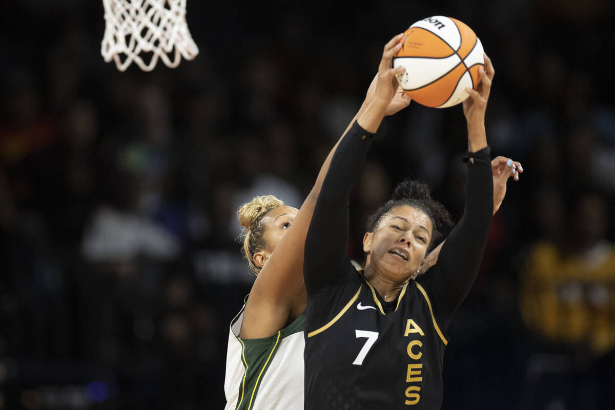 Las Vegas Aces forward Alysha Clark (7) snags a rebound over Seattle Storm center Mercedes Russ ...