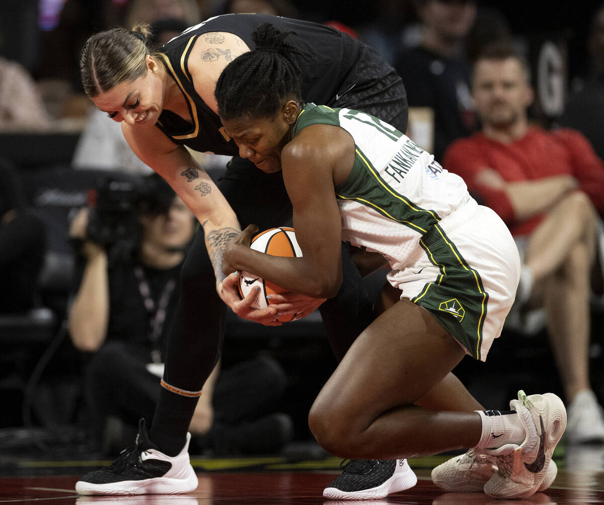 Las Vegas Aces forward Cayla George (13) and Seattle Storm forward Dulcy Fankam Mendjiadeu (12) ...