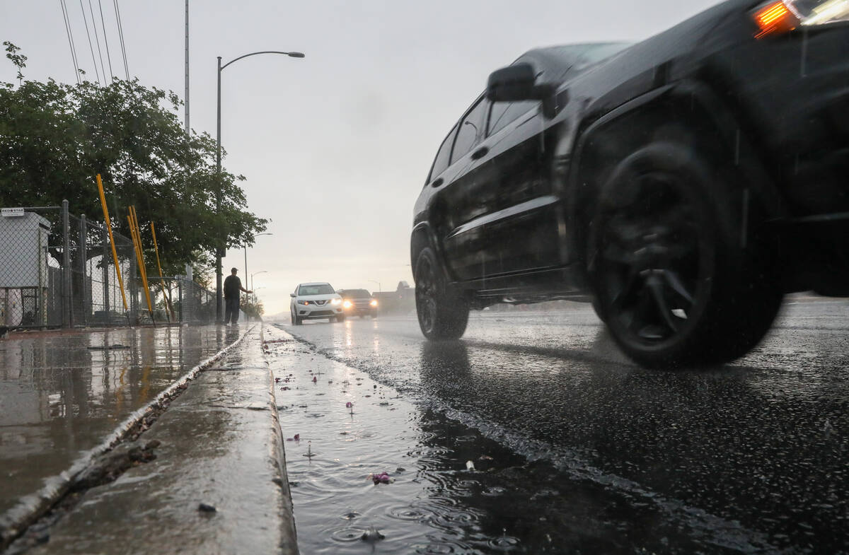 Cars drive along Warms Springs road during an early morning rain storm on Friday, June 16, 2023 ...