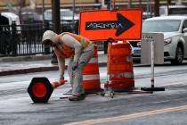 A worker fixes traffic cones, Tuesday, Feb. 14, 2023, in downtown Las Vegas. (Chitose Suzuki/La ...