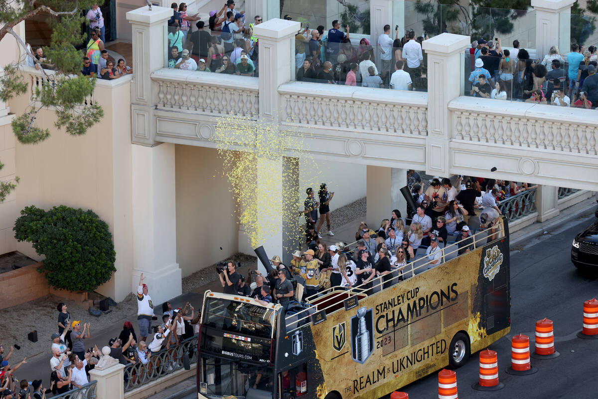 Fans cheer the Golden Knights’ Stanley Cup championship parade on Flamingo Road near the ...