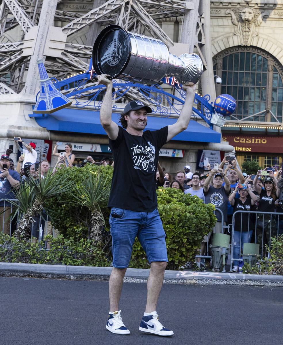 Golden Knights right wing Mark Stone holds the Stanley Cup as he celebrates with fans during a ...