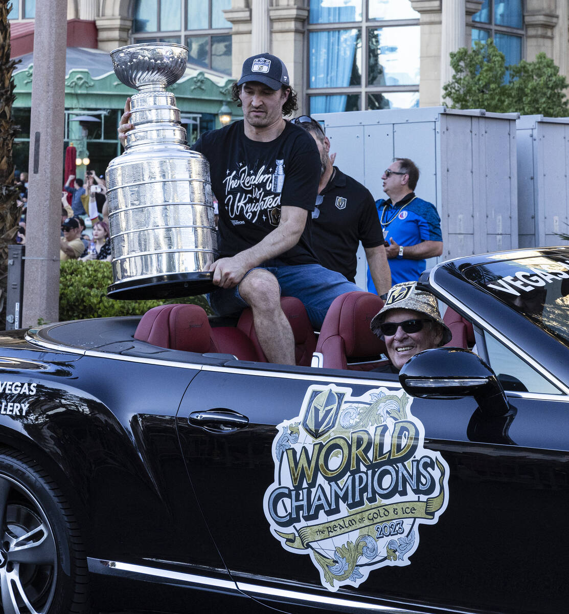 Golden Knights right wing Mark Stone holds the Stanley Cup as team owner Bill Foley, seated, lo ...
