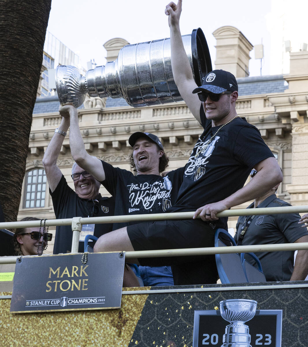 Golden Knights right wing Mark Stone, center, and team owner Bill Foley, left, hold the Stanley ...