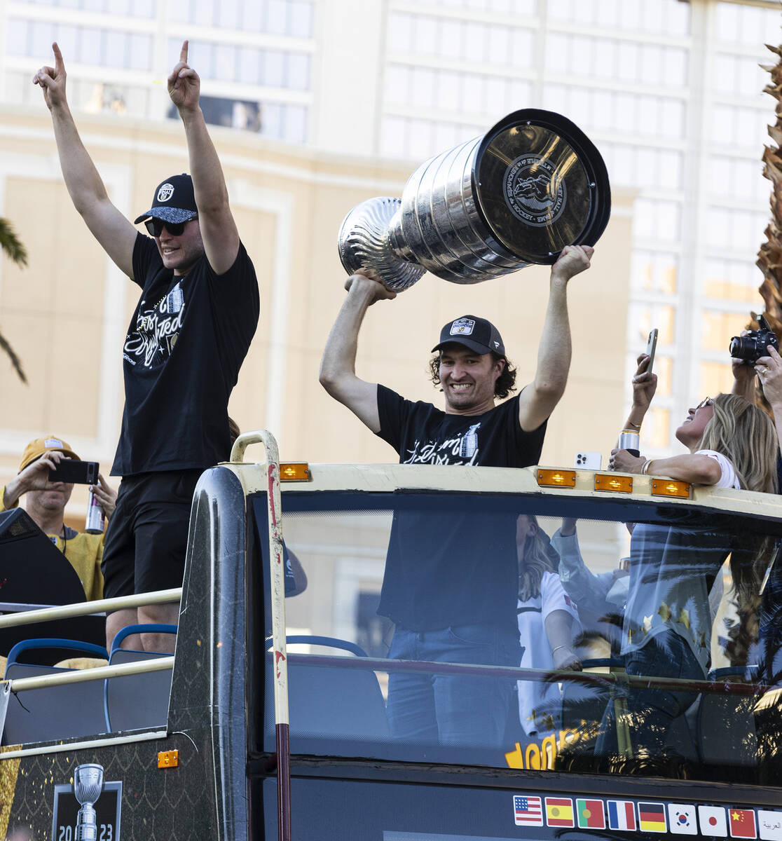 Golden Knights right wing Mark Stone, right, holds the Stanley Cup as he celebrates with fans d ...