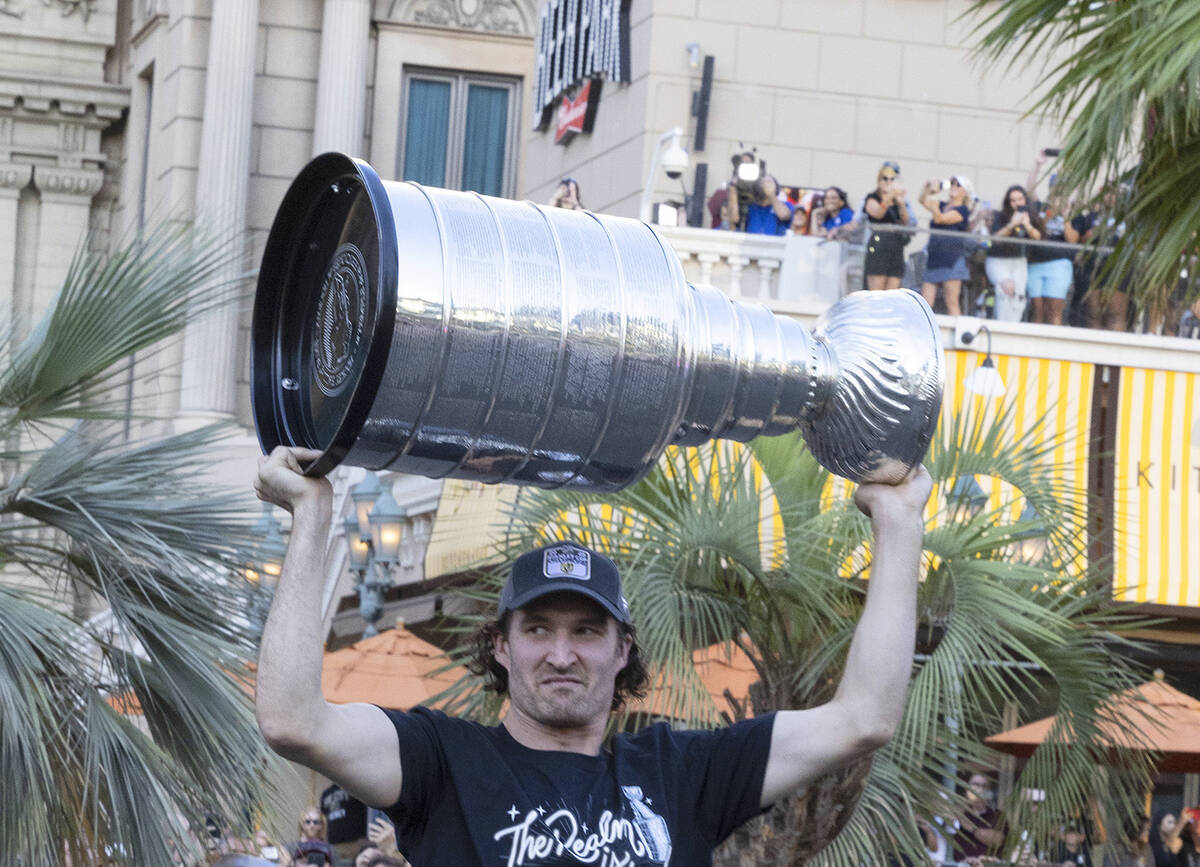 Golden Knights right wing Mark Stone holds the Stanley Cup as he celebrates with fans during a ...