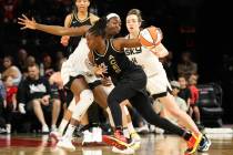 Aces guard Chelsea Gray (12) drives the ball past a Chicago Sky player during a game on Sunday, ...