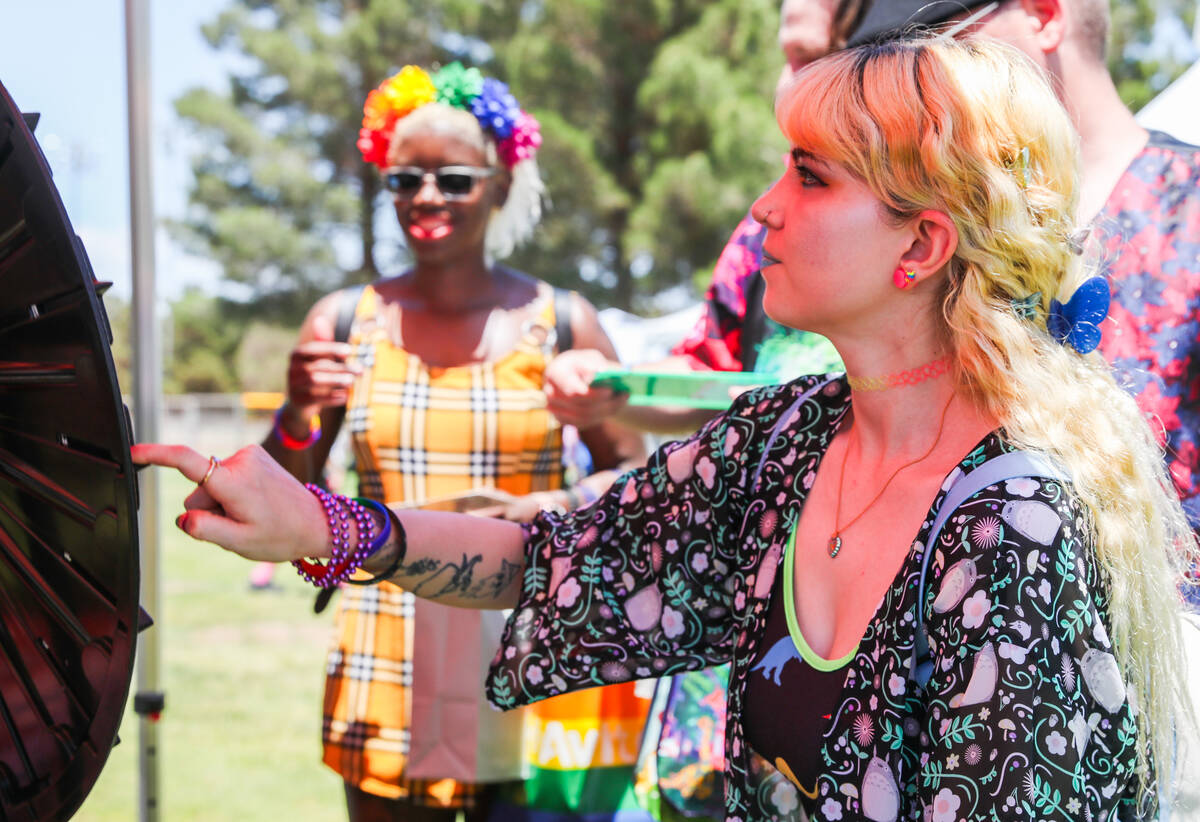 Isaki Voelker is cheered on by her friends as she spins the wheel to win prizes at the 3rd annu ...