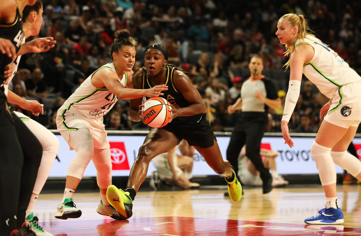 Las Vegas Aces guard Jackie Young (0) drives the ball to the net during a game against the Minn ...