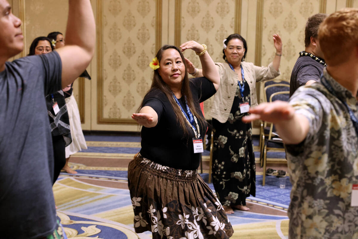 Melissa Naholopapa Castaneda of Long Beach, Calif., center, takes part in a hula workshop on Da ...