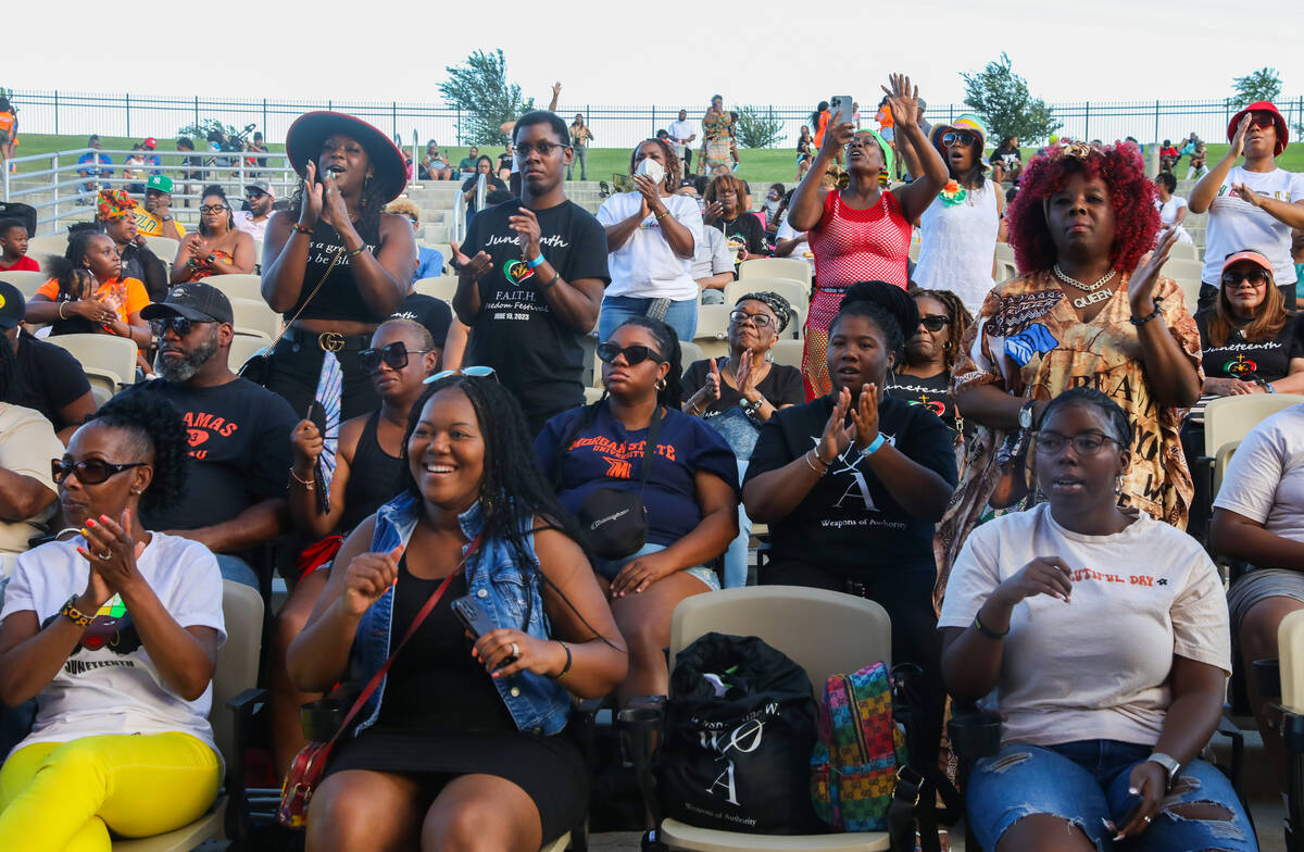 A crowd of people sing and dance along to performers at the F.A.I.T.H Juneteenth Freedom Festiv ...