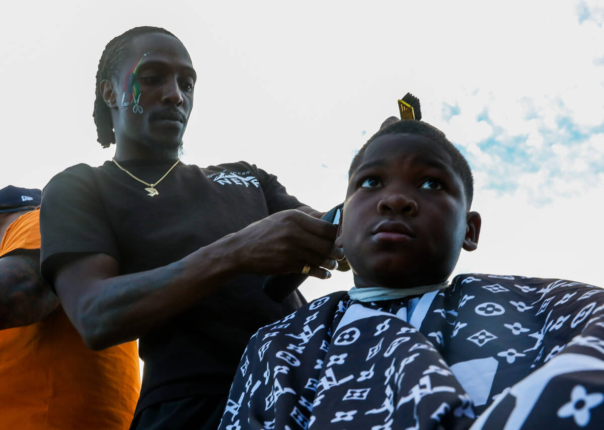 Makyi Owens gets his hair cut by Deshawn Stewart with Expertise Cosmetology and Barber Institut ...