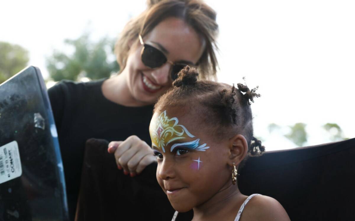Bella Stephens, 4, gets her face painted by Lauren-Rae Chismar at the F.A.I.T.H Juneteenth Free ...