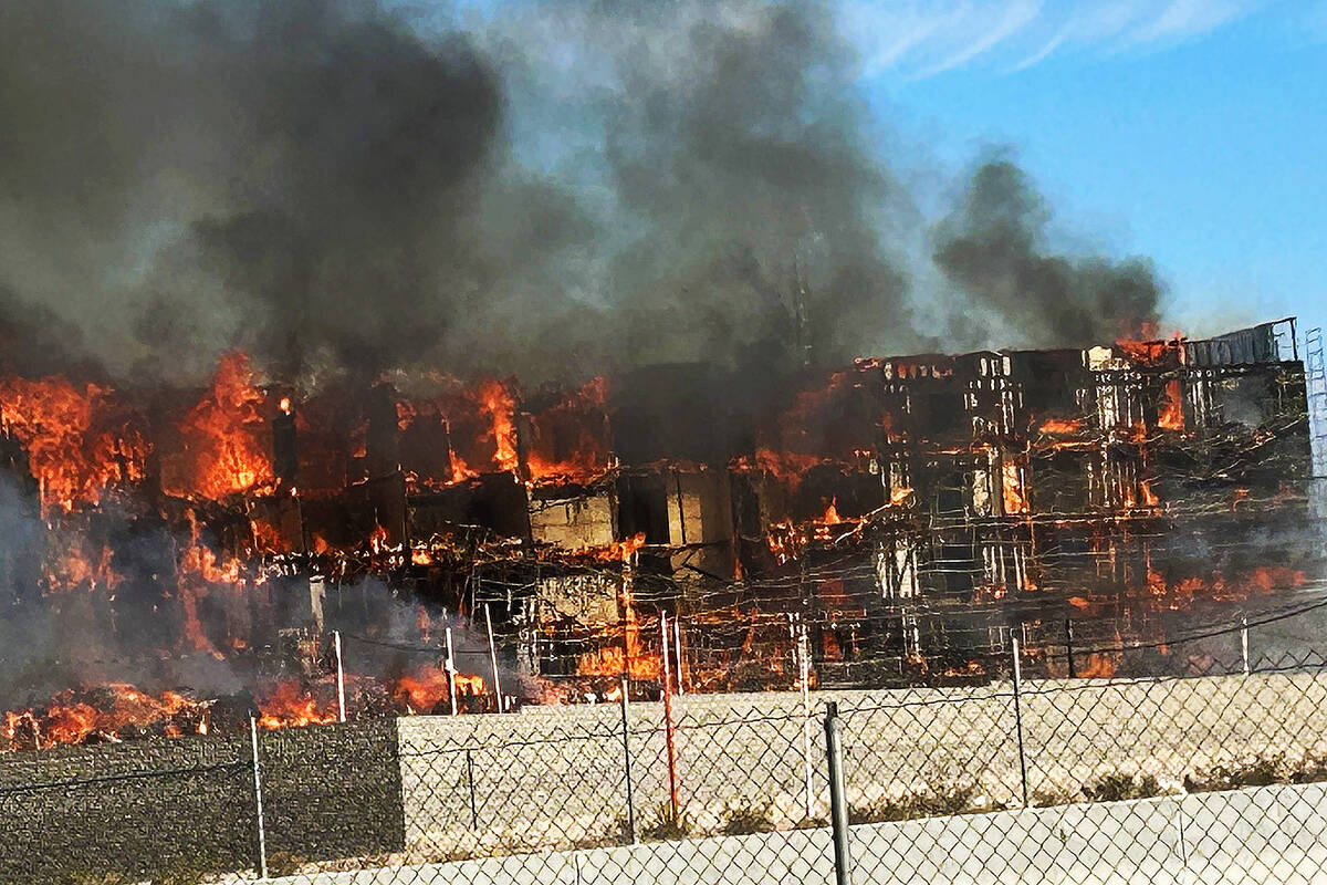 An under-construction residential complex burns near Buffalo Drive and the 215 Beltway. (Bizu T ...