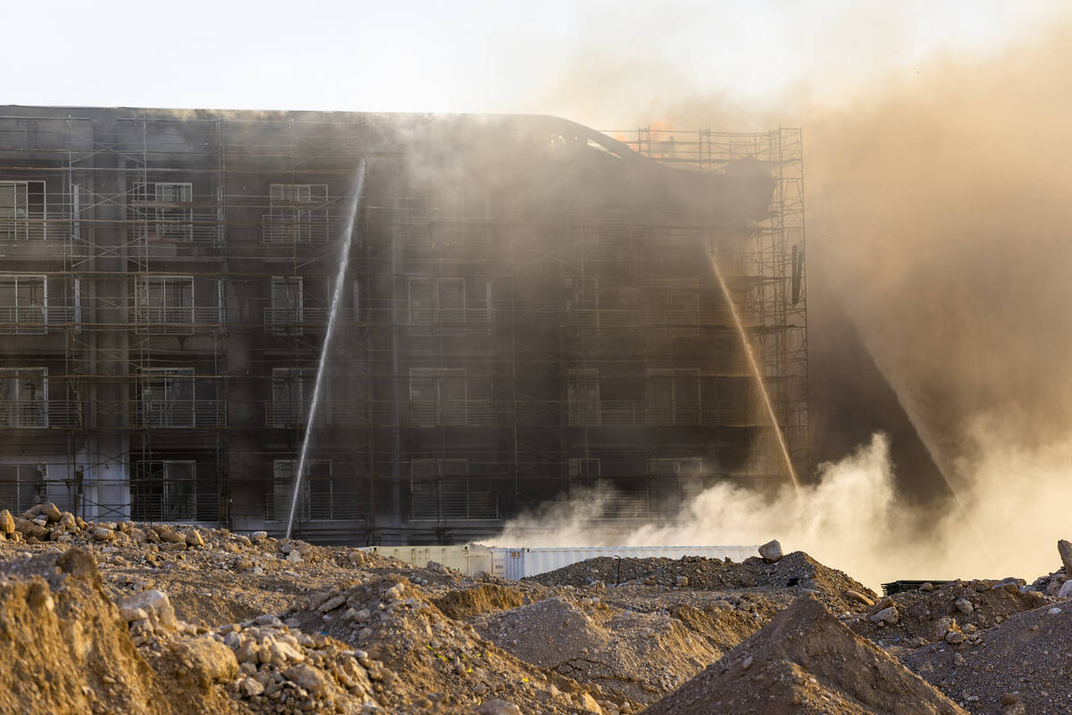 Firefighters work to extinguish a blaze at an under-construction residential complex near Buffa ...