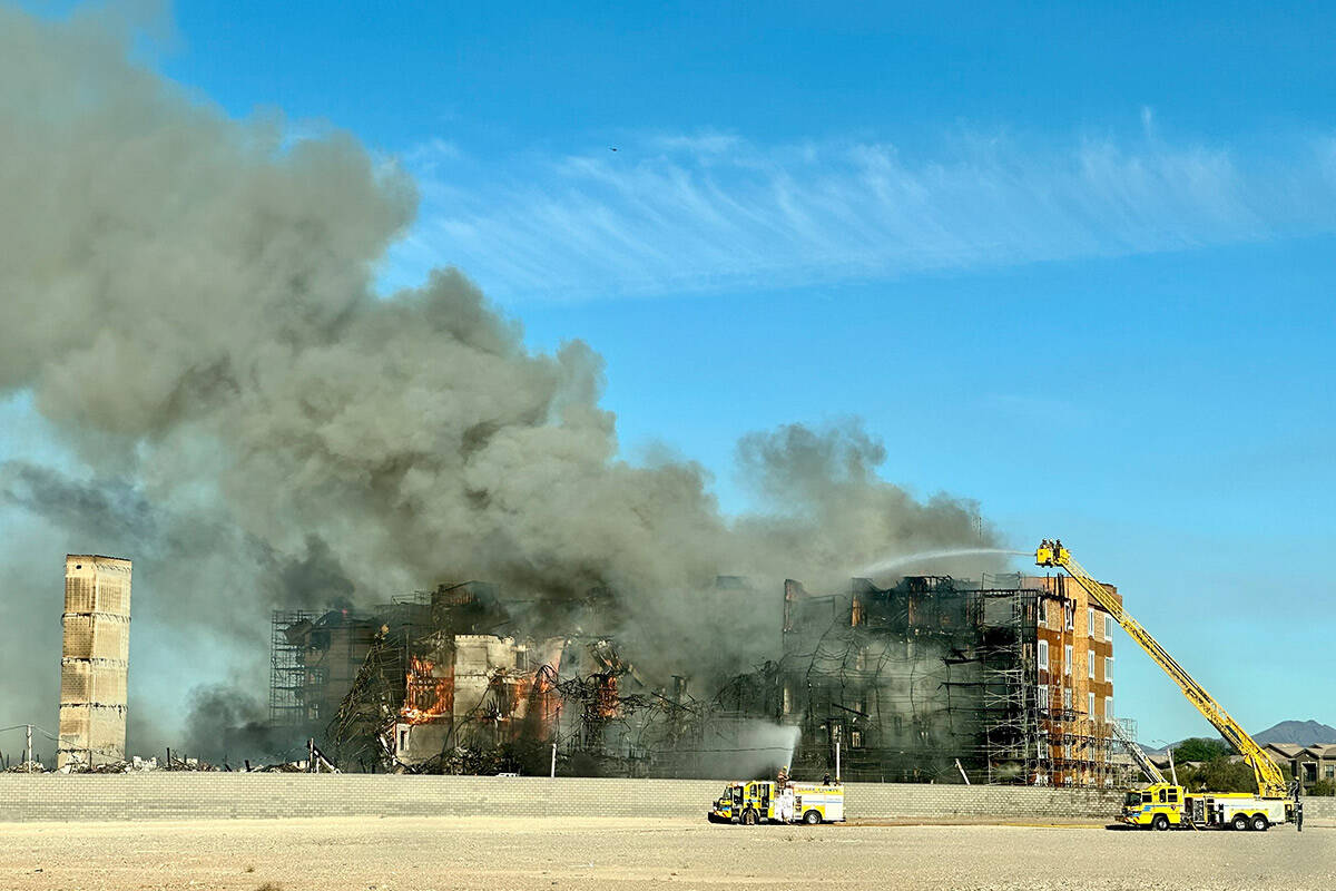 Firefighters work to extinguish a blaze at an under-construction residential complex near Buffa ...
