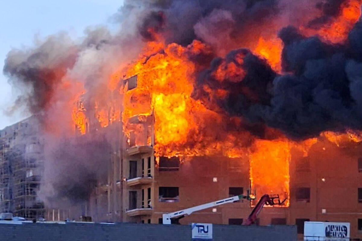 An under-construction residential complex burns near Buffalo Drive and the 215 Beltway. (Clark ...