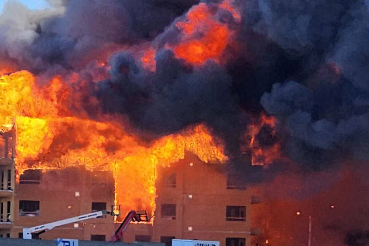 An under-construction residential complex burns near Buffalo Drive and the 215 Beltway. (Clark ...