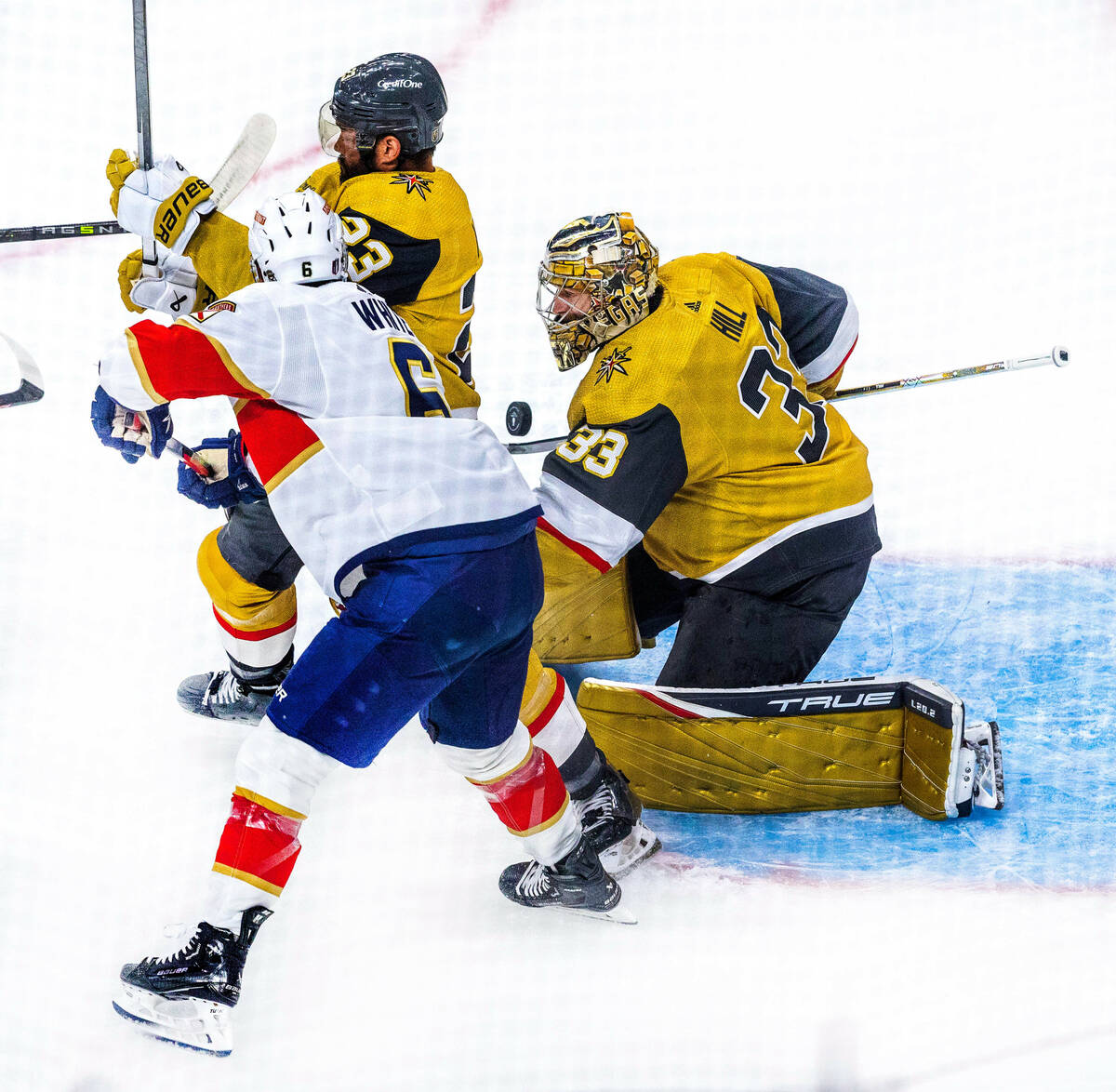 Golden Knights goaltender Adin Hill (33) deflects a shot crowded by Florida Panthers center Col ...