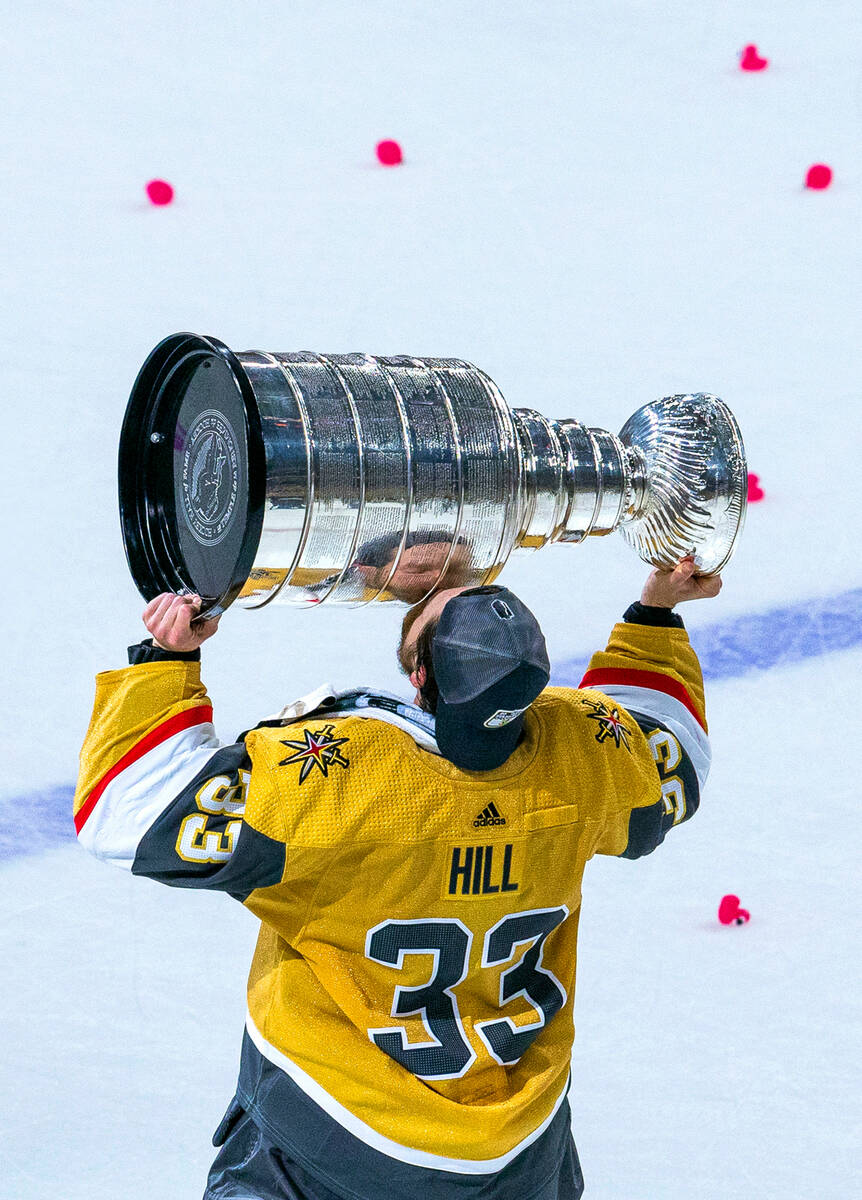 Golden Knights goaltender Adin Hill (33) kisses the Stanley Cup after defeating the Florida Pan ...