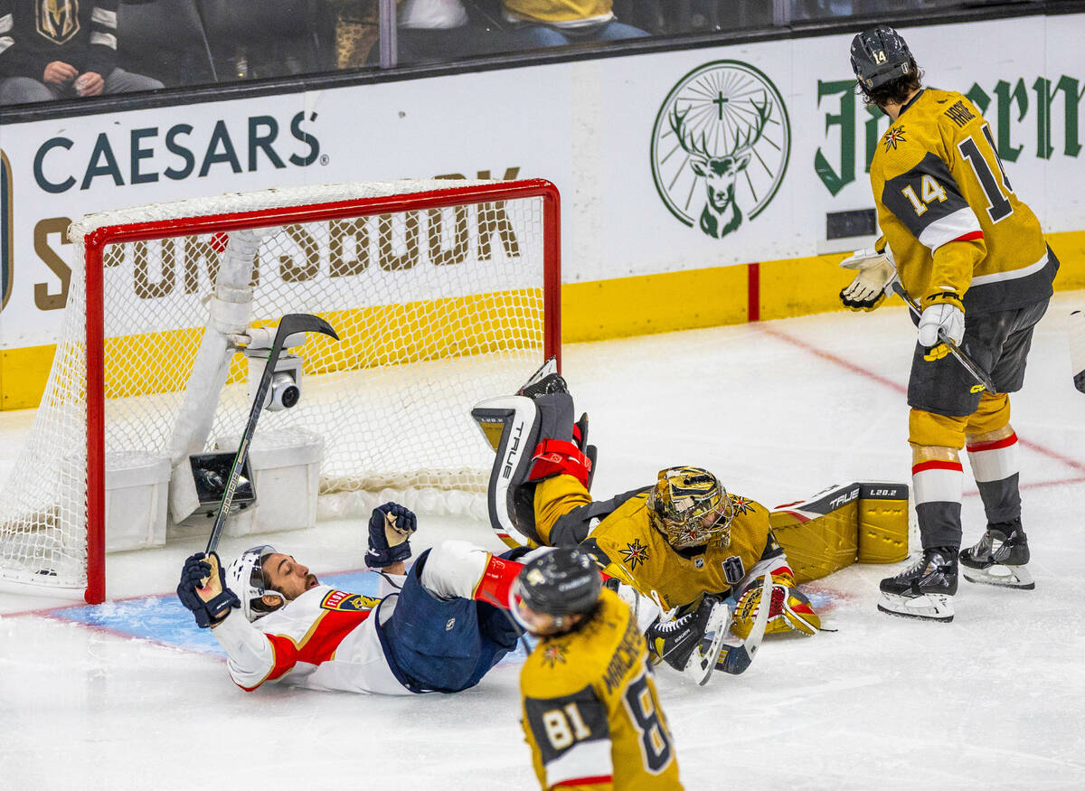 Florida Panthers left wing Ryan Lomberg (94) tumbles over Golden Knights goaltender Adin Hill ( ...